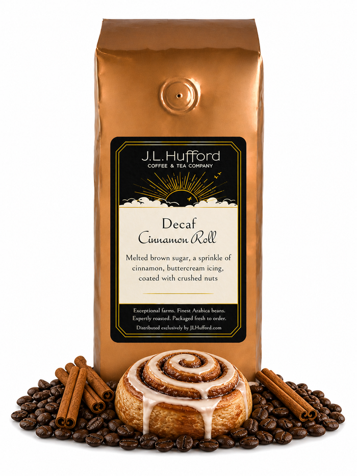1 lb Decaf Cinnamon Roll coffee beans bag with coffee beans, cinnamon sticks, and cinnamon roll in front displayed on a white background