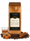 1 lb English Caramel coffee beans bag with coffee beans, cinnamon sticks, blocks of caramel, and a glass of rum in front displayed on a white background