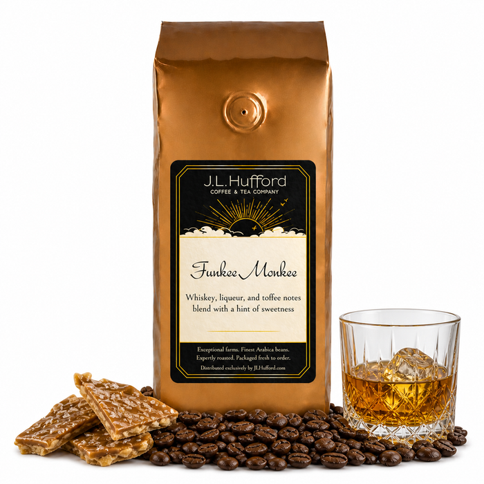 1 lb Funkee Monkee coffee beans bag with coffee beans, toffee bark, and a glass of whiskey in front displayed on a white background