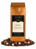 1 lb J.L. Hufford Hazelnut coffee bag with coffee beans and hazelnuts on a white background