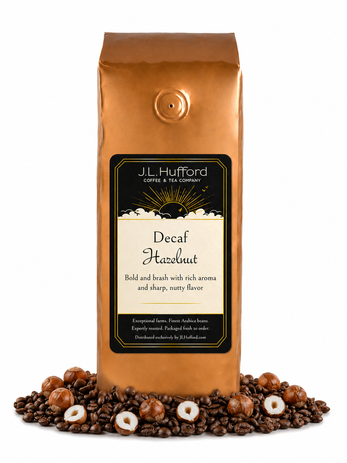 1 lb J.L. Hufford Decaf Hazelnut coffee bag with coffee beans and hazelnuts on a white background