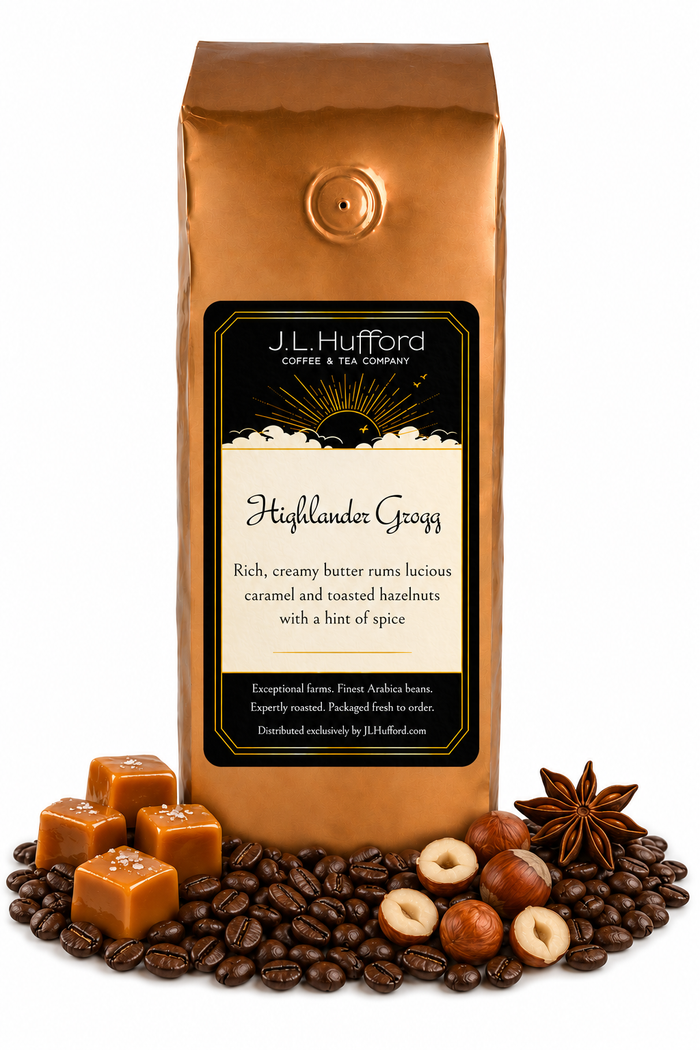 1 lb J.L. Hufford Highlander Grogg coffee bag with coffee beans, blocks of caramel, hazelnuts, and spice on a white background