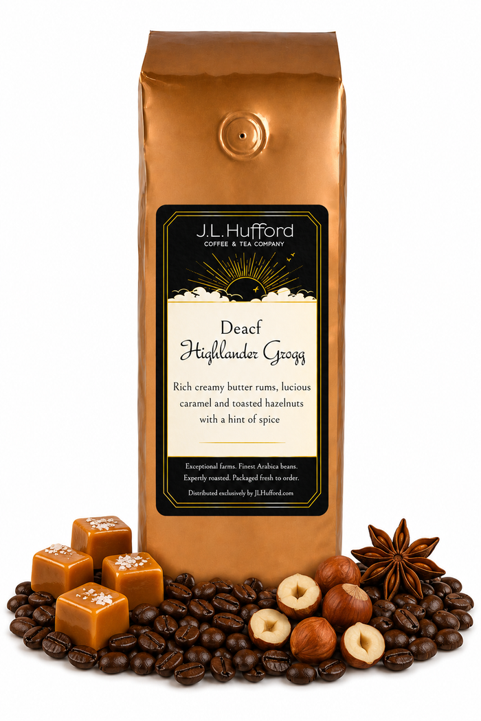 1 lb J.L. Hufford Decaf Highlander Grogg coffee bag with coffee beans, blocks of caramel, hazelnuts, and spice on a white background