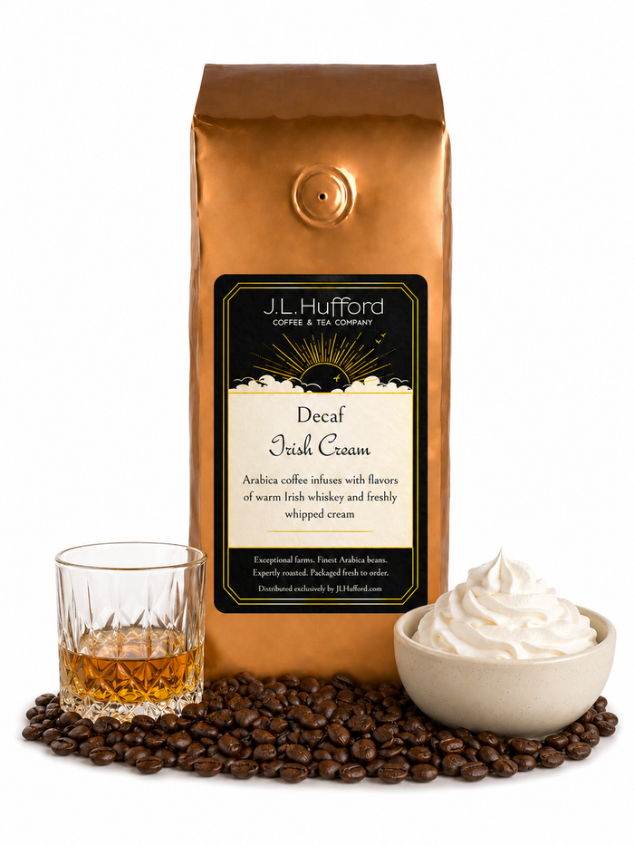 1 lb J.L. Hufford Decaf Irish Cream coffee bag with coffee beans, glass of Irish whiskey, and bowl of whipped cream on a white background