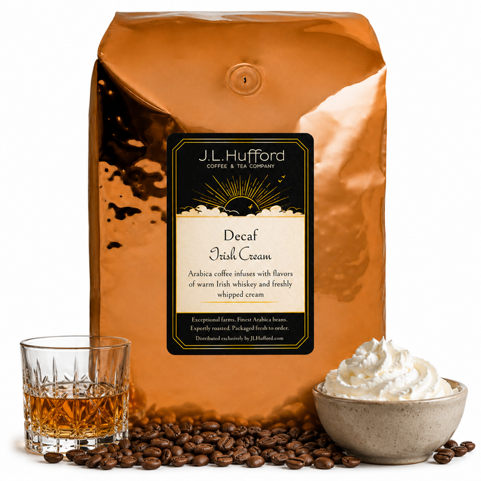 5 lb J.L. Hufford Decaf Irish Cream coffee bag with coffee beans, glass of Irish whiskey, and bowl of whipped cream on a white background