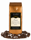 1 lb J.L. Hufford Mounds coffee bag with coffee beans, blocks of chocolate, and flakes of coconut on a white background