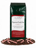 1 lb Peppermint Candy Cane coffee beans bag with coffee beans and peppermint candy canes in front displayed on a white background