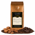 1 lb J.L. Hufford Praline Caramel Swirl Coffee with coffee beans, roasted pralines, caramel blocks, and dark chocolate bars in front displayed on a white background