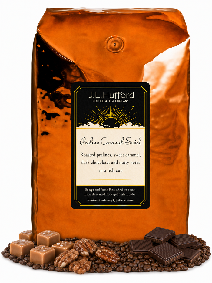5 lb J.L. Hufford Praline Caramel Swirl Coffee with coffee beans, roasted pralines, caramel blocks, and dark chocolate bars in front displayed on a white background