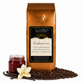 1 lb J.L. Hufford Raspberry Cream coffee bag with coffee beans, vanilla sticks, and a jar of raspberry jam on a white background