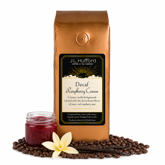 1 lb J.L. Hufford Decaf Raspberry Cream coffee bag with coffee beans, vanilla sticks, and a jar of raspberry jam on a white background