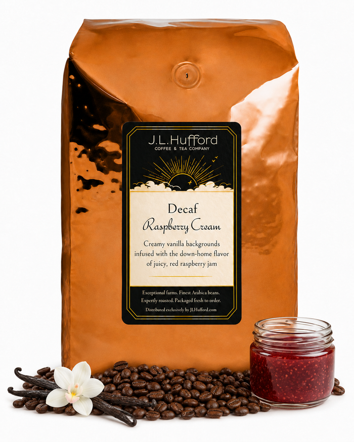 5 lb J.L. Hufford Decaf Raspberry Cream coffee bag with coffee beans, vanilla sticks, and a jar of raspberry jam on a white background
