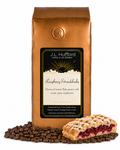 1 lb J.L. Hufford Raspberry Streudelcake coffee bag with coffee beans and a slice of raspberry streudelcake on a white background