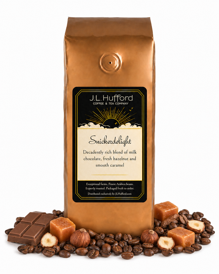 1 lb J.L. Hufford Snickerdelight coffee bag with coffee beans, milk chocolate bar, hazelnuts, and blocks of caramel on a white background