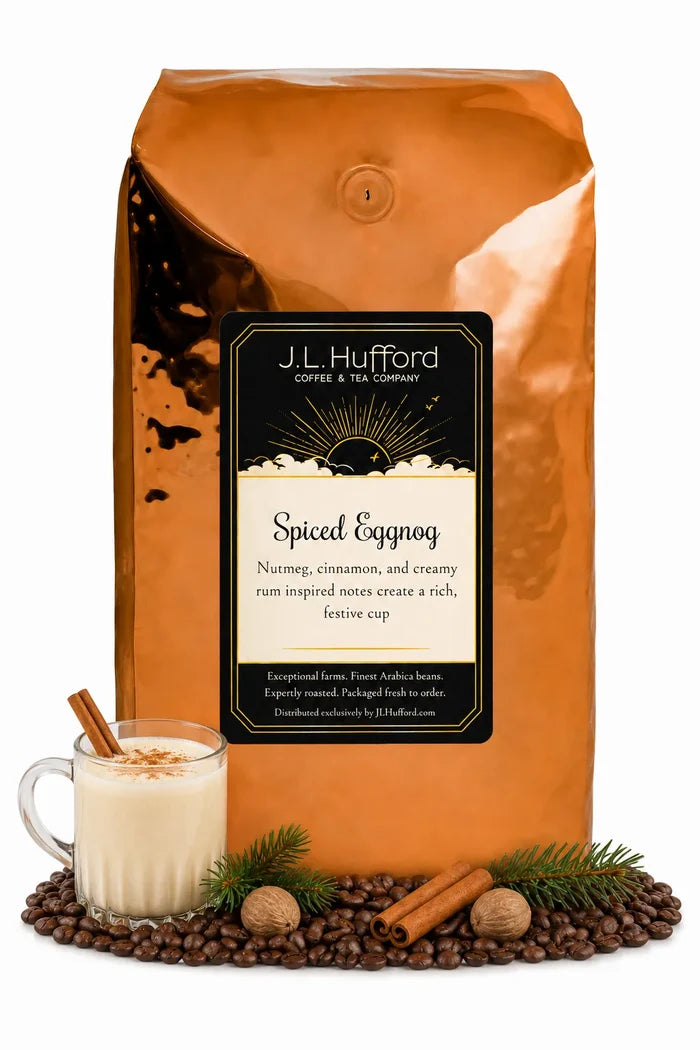5 lb J.L. Hufford Spiced Eggnog coffee bag with coffee beans, glass of eggnog, pine needles, and cinnamon sticks on a white background