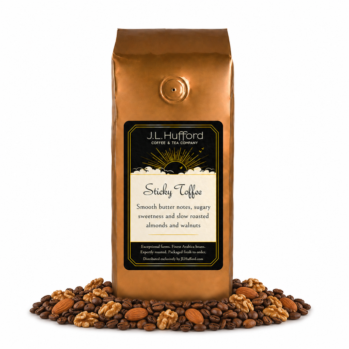 1 lb J.L. Hufford Sticky Toffee Coffee with coffee beans and roasted almonds and walnuts in front displayed on a white background