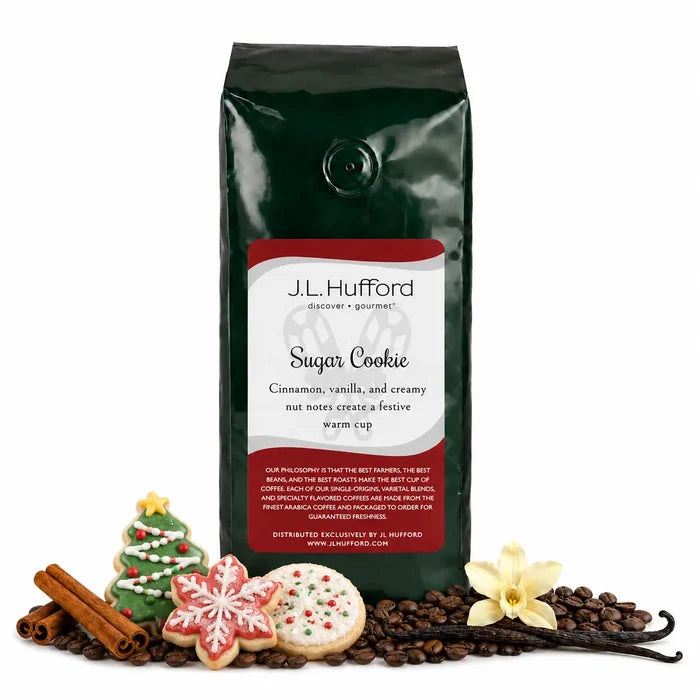 1 lb J.L. Hufford Sugar Cookie coffee bag with coffee beans, Christmas sugar cookies, cinnamon sticks, and vanilla on a white background
