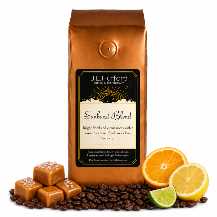 1 lb Sunburst Blend coffee beans bag with coffee beans, salted caramel blocks, and citrus items in front displayed on a white background