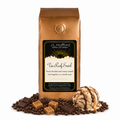 1 lb J.L. Hufford Tin Roof Swirl Coffee with coffee beans, chocolate bars, caramel blocks, and ice cream with drizzled fudge and caramel in front displayed on a white background