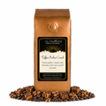 1 lb J.L. Hufford Toffee Praline Crunch coffee bag with coffee beans, praline, and caramel blocks drizzled with chocolate on a white background