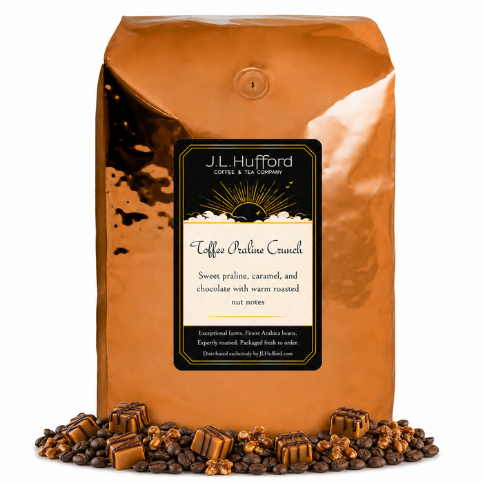 5 lb J.L. Hufford Toffee Praline Crunch coffee bag with coffee beans, praline, and caramel blocks drizzled with chocolate on a white background