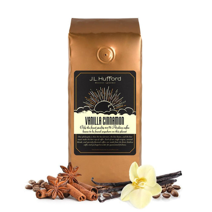 1 lb Vanilla Cinnamon coffee bag with cinnamon sticks, flower, coffee beans, and vanilla stick in front displayed on a white background