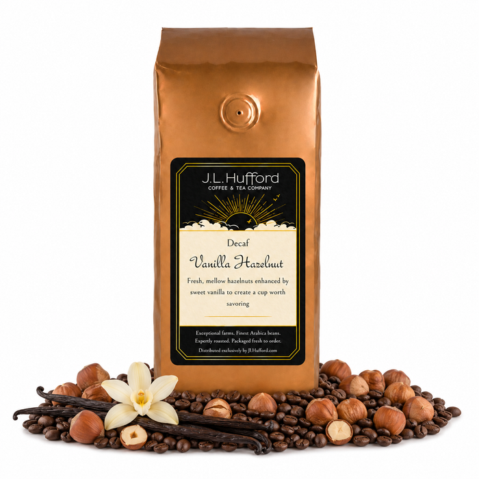 1 lb J.L. Hufford Decaf Vanilla Hazelnut coffee bag with coffee beans, vanilla sticks, and hazelnuts on a white background
