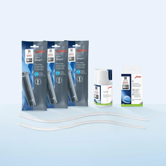 Jura coffee machine cleaning kit with three Smart+ filter pouches, a bottle to hold tablet cleaners, a box of tablet cleaners, and two clear replacement tubes on a light blue gradient background.