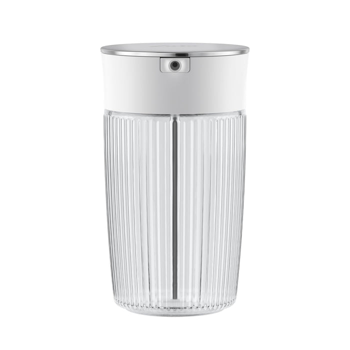 A clear glass milk carafe with a stainless steel lid, featuring a ribbed exterior and a thick base on a white background