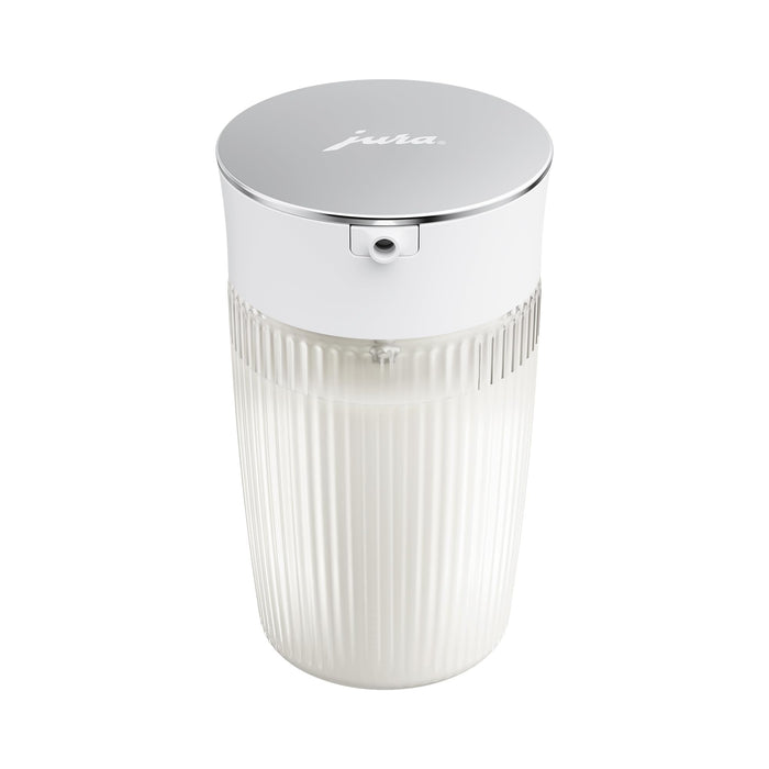 Jura 16.9oz glass milk carafe with lid in with milk inside the carafe on a white background