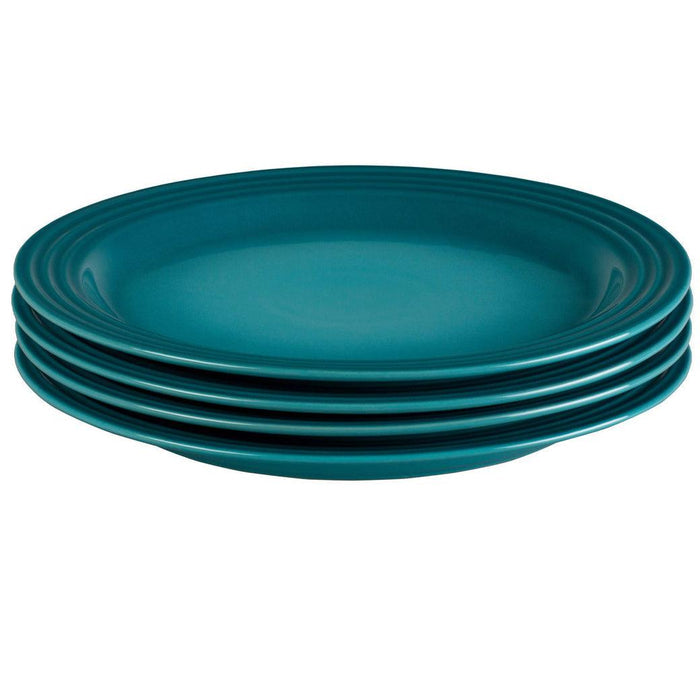 Set of 4 Caribbean Le Creuset plates displayed on a white background