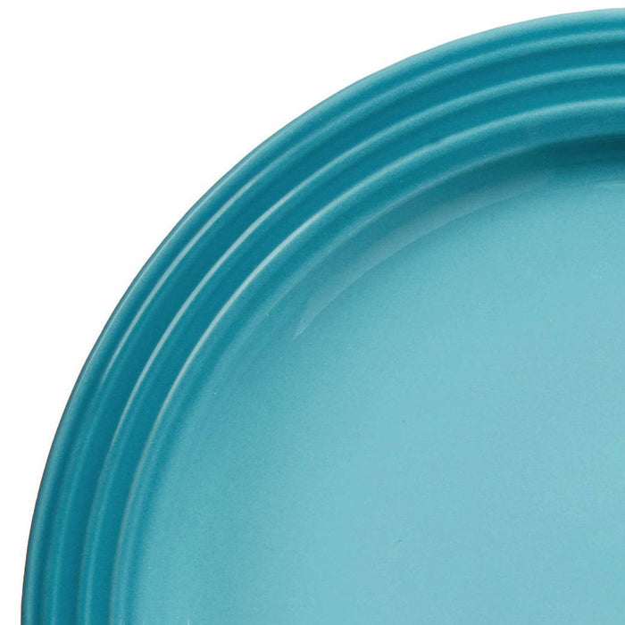Close up of Caribbean Le Creuset plate displayed on a white background