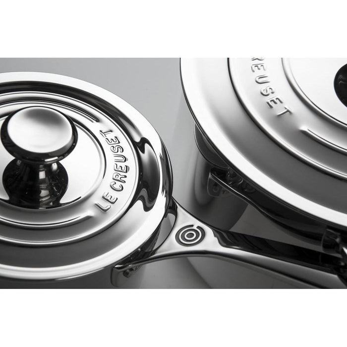 Close up of 2 Le Creuset Stainless Steel cookware with lids