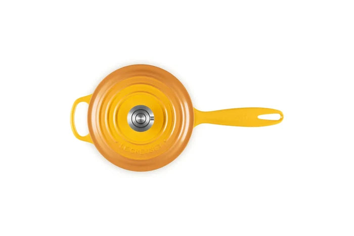 A bright yellow cast iron Dutch oven with a lid, shown from a top-down view on a solid white background.