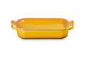 A rectangular yellow ceramic baking dish with side handles and lid, shown on a clean white background.