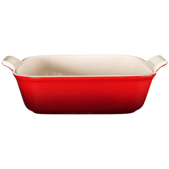Side view of Cerise Le Creuset 3 qt Heritage Square Dish displayed on a white background