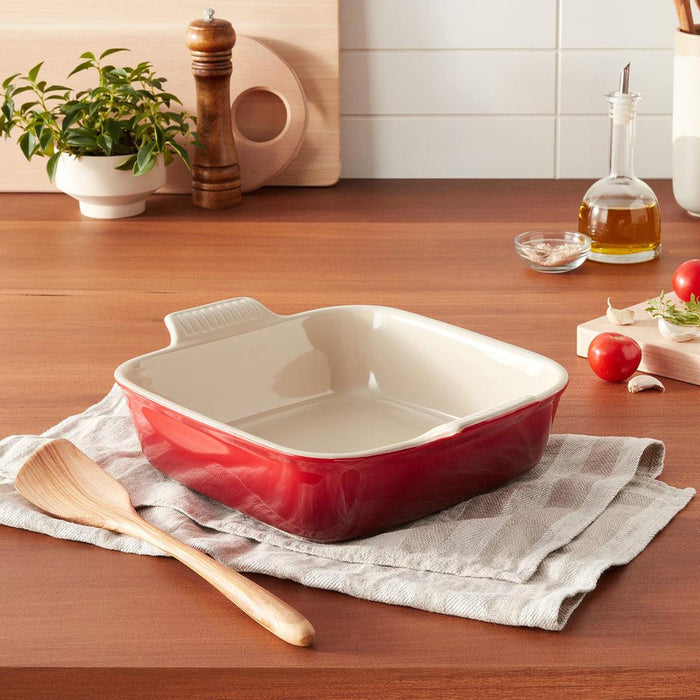Cerise Le Creuset 3 qt Heritage Square Dish displayed in a kitchen setting on a tablecloth