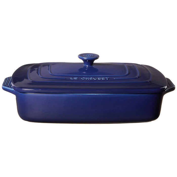 3.5 qt dark blue Le Creuset covered rectangular casserole displayed on a white background
