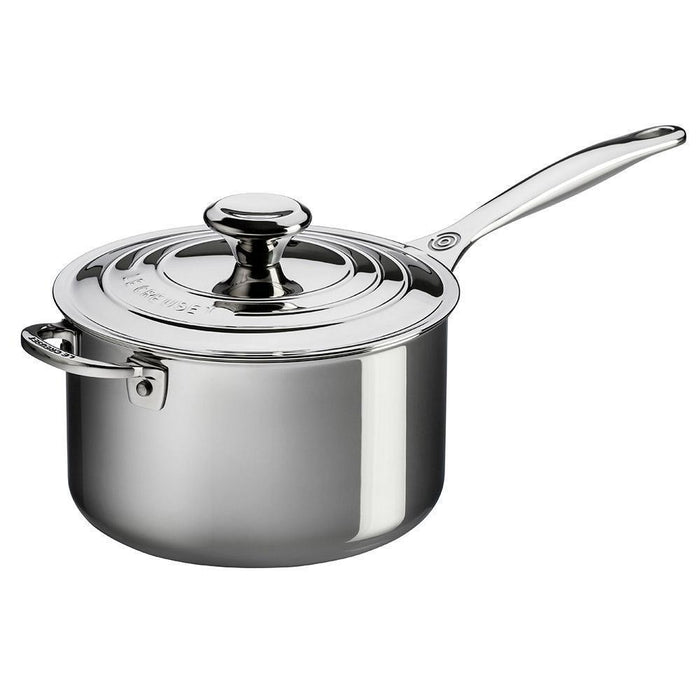 Le Creuset 4 Qt. Stainless Steel Saucepan with Lid and Helper Handle from a side view displayed on a white background