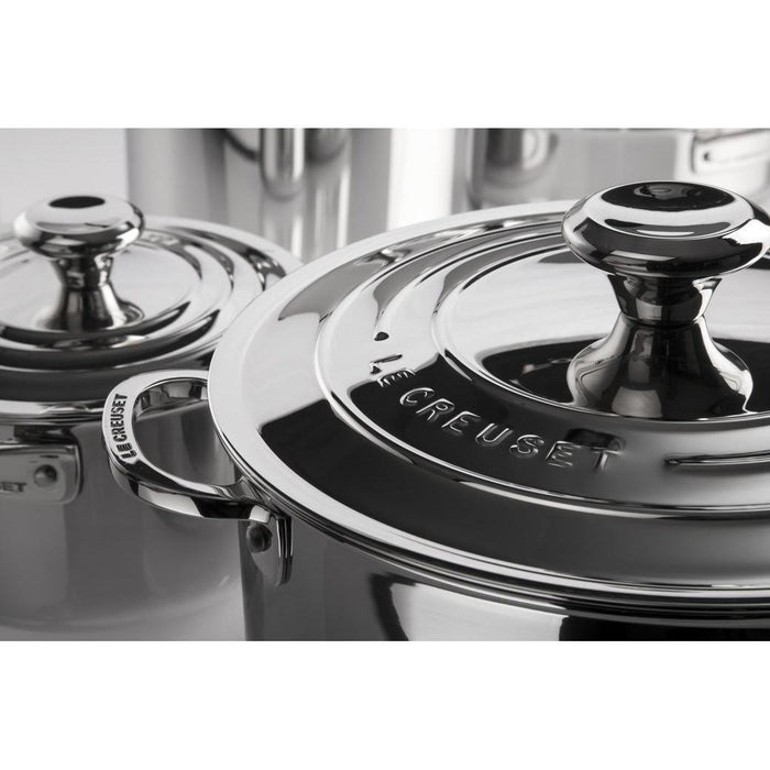 Close up view of stainless steel stockpots from Le Creuset with branding on the lid