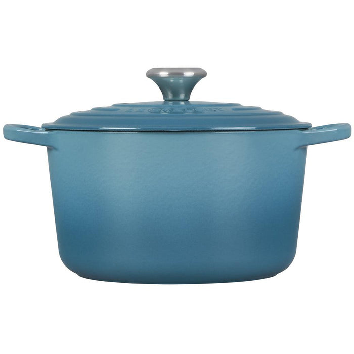 Caribbean 5.25 Qt Deep Le Creuset enameled cast iron Dutch oven with the lid on from the side view on t=a white background