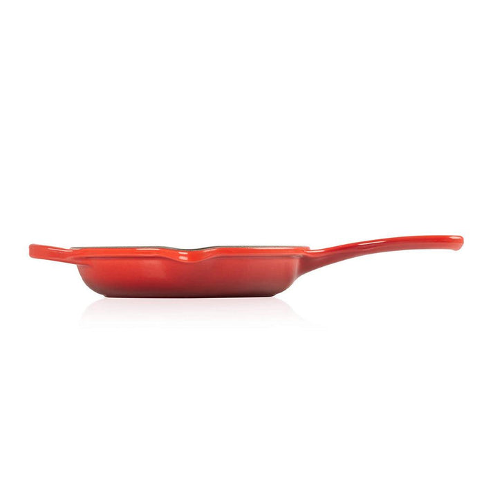 Cerise 6.33" Le Creuset skillet from the side view on a white background