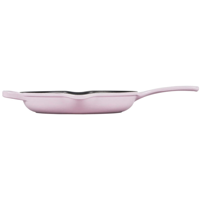 Side view of 9 inch shallot cast iron handle skillet displayed on a white background