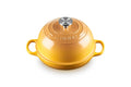A yellow Le Creuset enameled cast iron pot with a matching lid, featuring side handles and a silver knob, set against a plain white background.