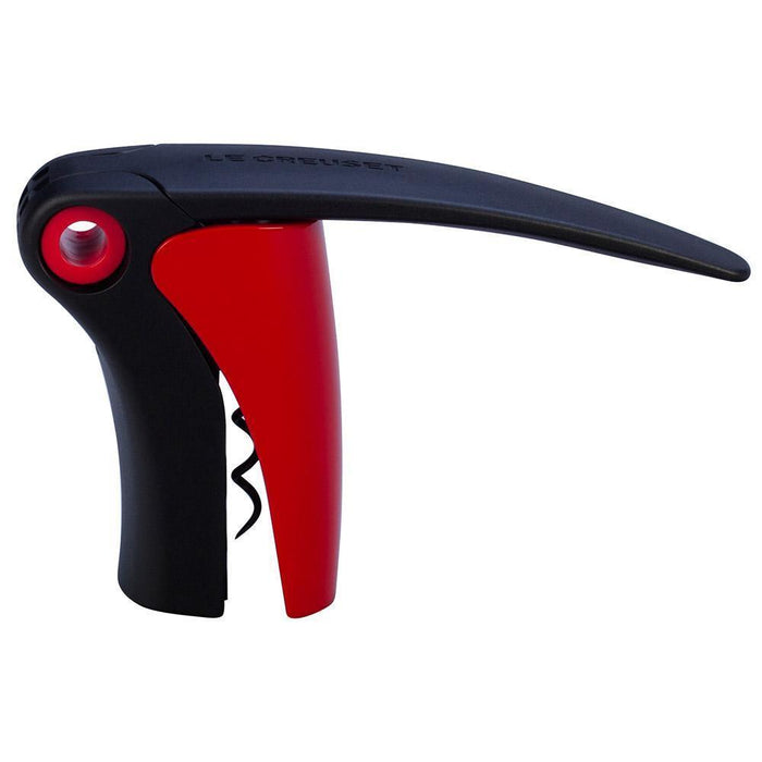 Side view of red handled Le Creuset Compact Lever Corkscrew on a white background