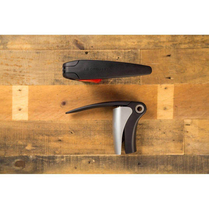 Birds eye view of the side and top view of Le Creuset Compact Lever Corkscrew displayed on a wooden surface