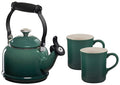 Green teakettle with black handle and two matching green mugs on a white background