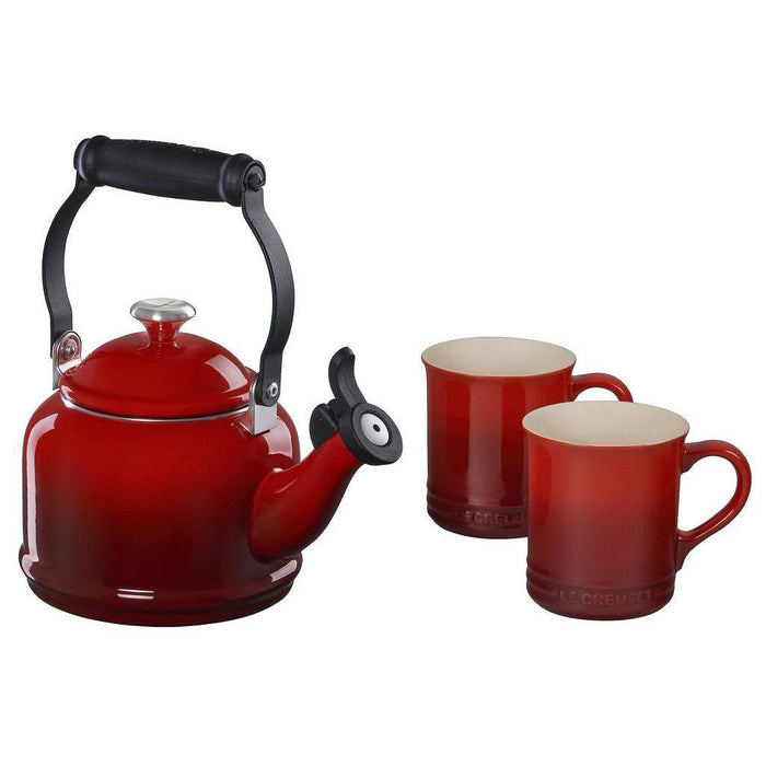 Cerise tea kettle with two cerise colored mugs displayed on a white background