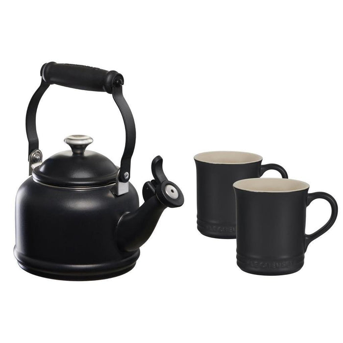 Licorice tea kettle with two licorice colored mugs displayed on a white background