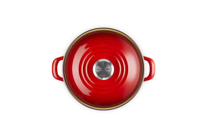 Top view of the cerise 3.8 qt enamel on steel traditional petite stockpot with lid and handles on a white background